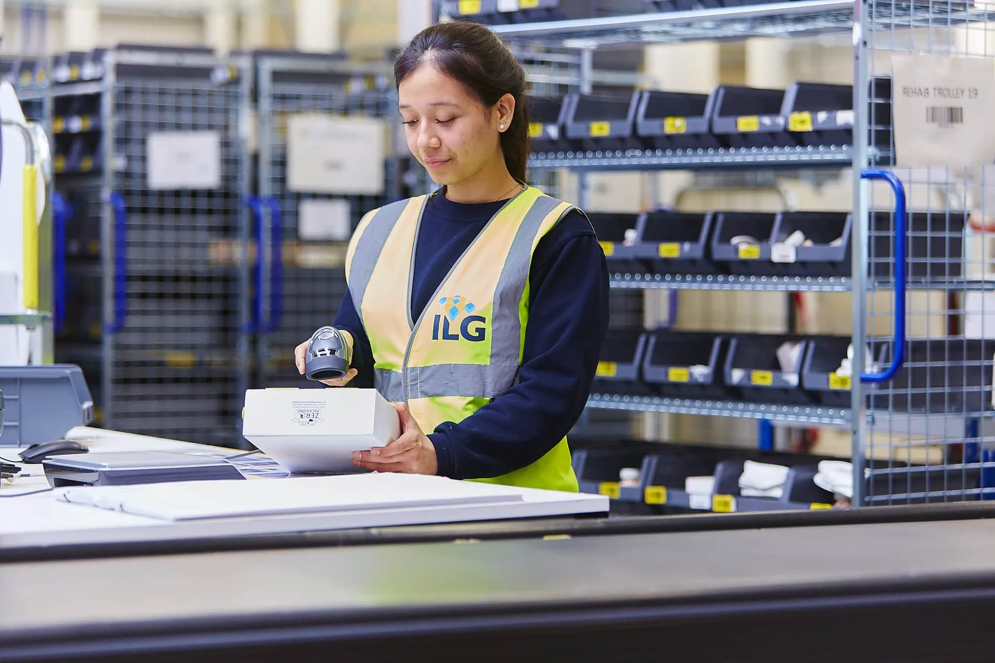 ILG woman scanning box in warehouse