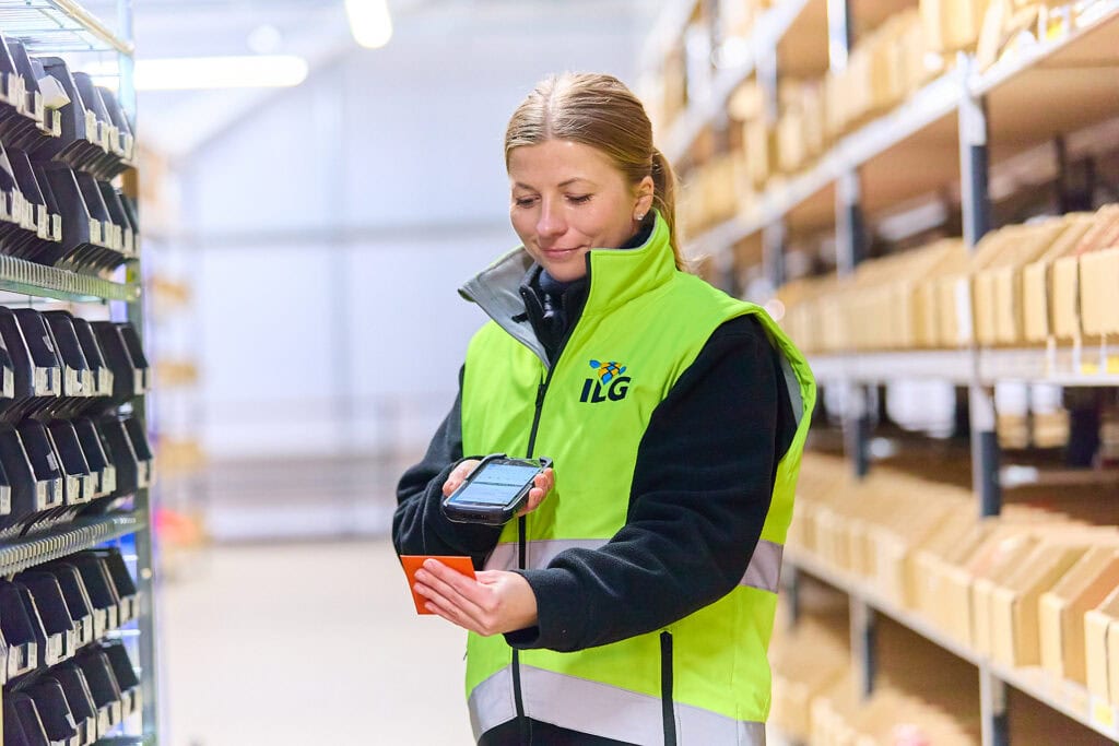 Lady scanning product in warehouse aisle