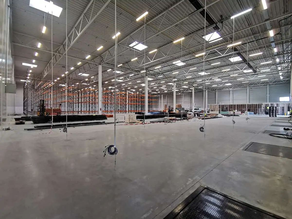 inside of a warehouse which is being fitted out with racking
