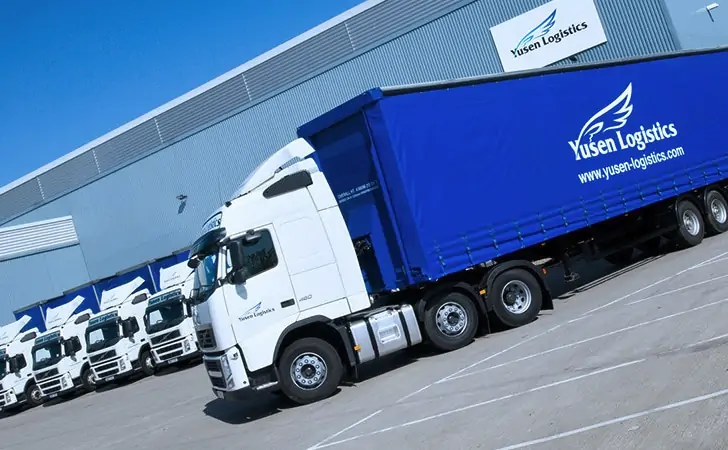 Yusen Logistics lorries parked outside of a Yusen Logistics warehouse